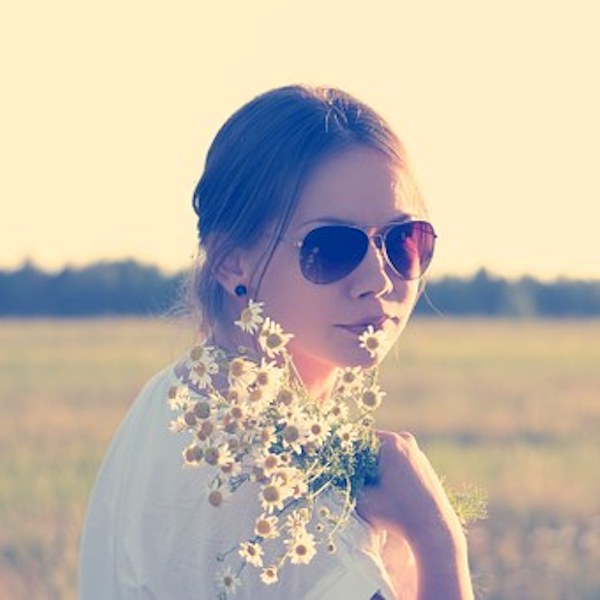 girl in sunshine with chamomile